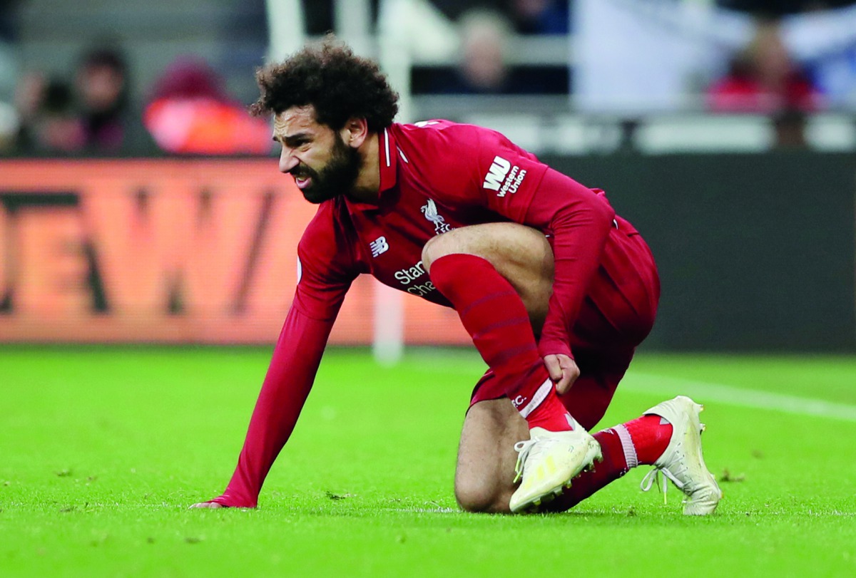  Liverpool's Mohamed Salah reacts after sustaining an injury. Reuters/Scott Heppell
