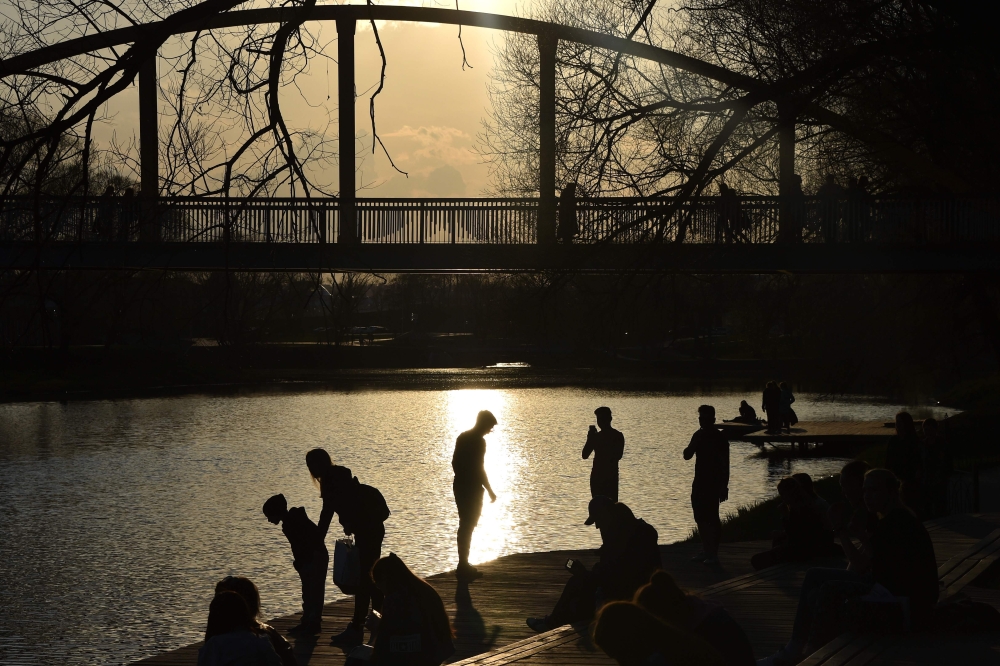 People rest in the park on the renovated embankment of the Vezelka river in the Russian city of Belgorod, some 700 km south of Moscow, on April 10, 2019.  AFP / Vasily Maximov 