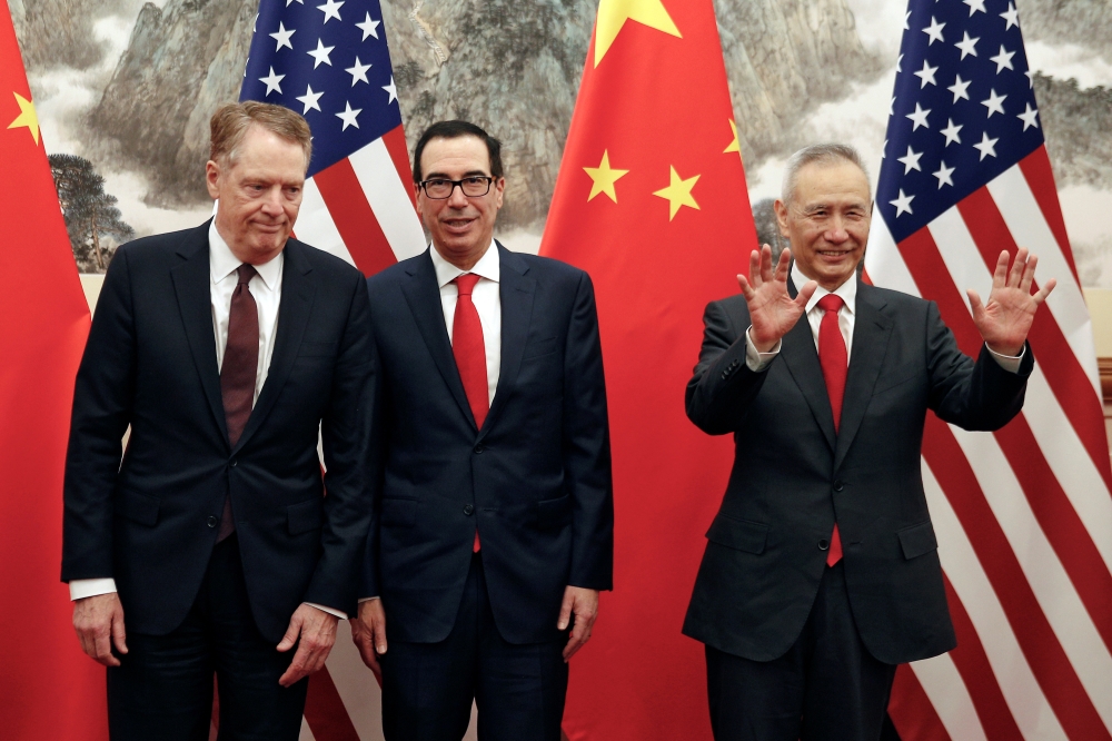 Chinese Vice Premier Liu He, right, gestures as U.S. Treasury Secretary Steven Mnuchin, center, chats with his Trade Representative Robert Lighthizer, left, before they proceed to their meeting at the Diaoyutai State Guesthouse in Beijing, Wednesday, May 