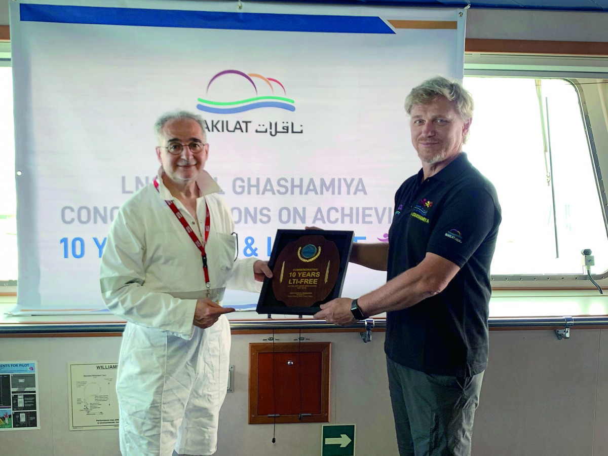The officials posing with the safety milestone award. 