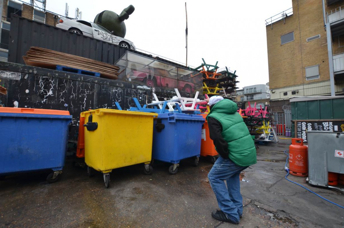 A homeless man working as a tourist guide for social enterprise Unseen Tours points at a street-art installation near Brick Lane, London on November 11, 2017. Umberto Bacchi / Thomson Reuters Foundation
