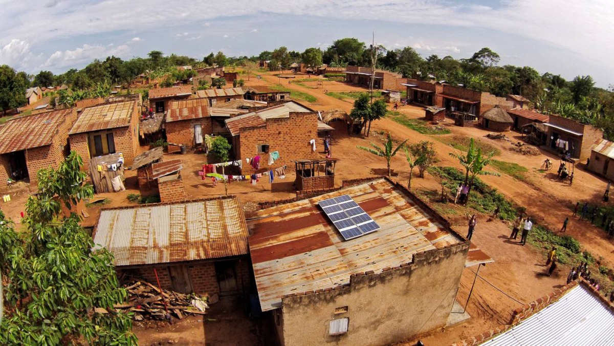 A photo taken from above by a drone shows solar panels on a rooftop in a Ugandan village. /SunFunder/Solar Now