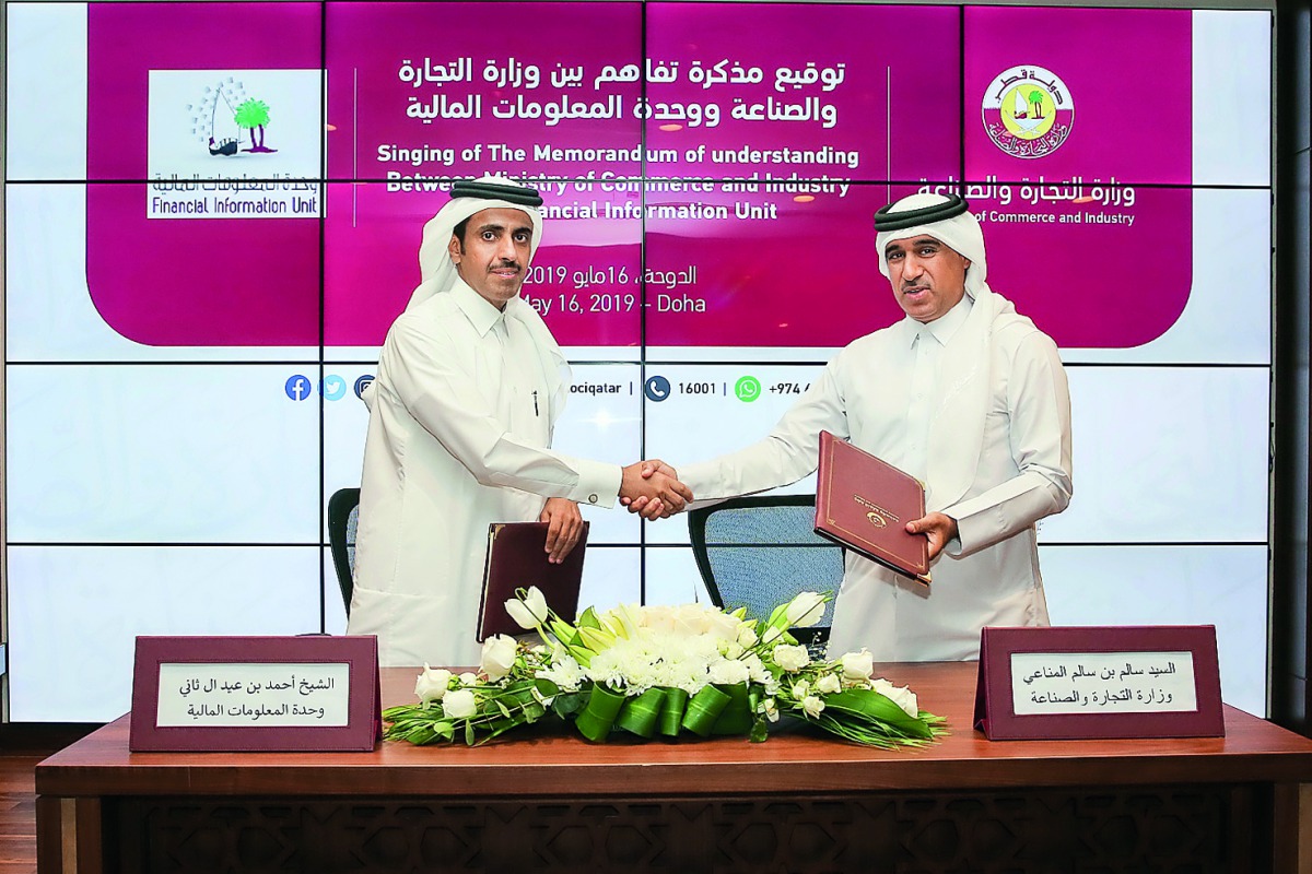 Salem bin Salim Al Mannai (right), Director of Corporate Affairs at the Ministry of Commerce and Industry, and Sheikh Ahmed bin Eid Al Thani, Head of  Qatar Financial Information Unit, at the MoU signing ceremony in Doha, yesterday. 