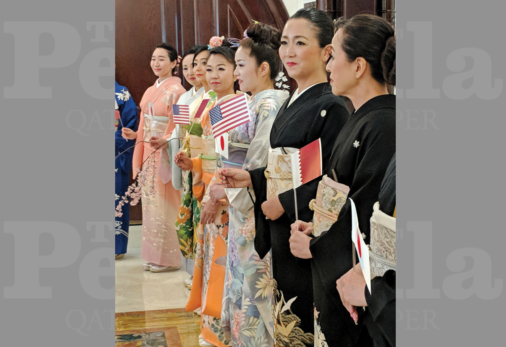  The participants in kimonos holding  flags.