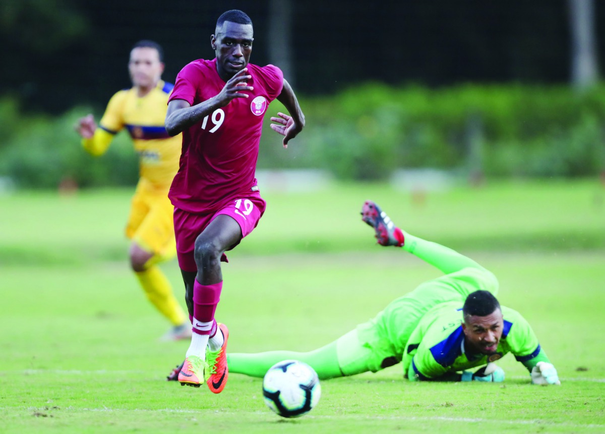 Qatar’s Almoez Ali (left) beats Club Madureira’s goalkeeper during their friendly match played in Mangaratiba, Rio de Janeiro, on Sunday. 