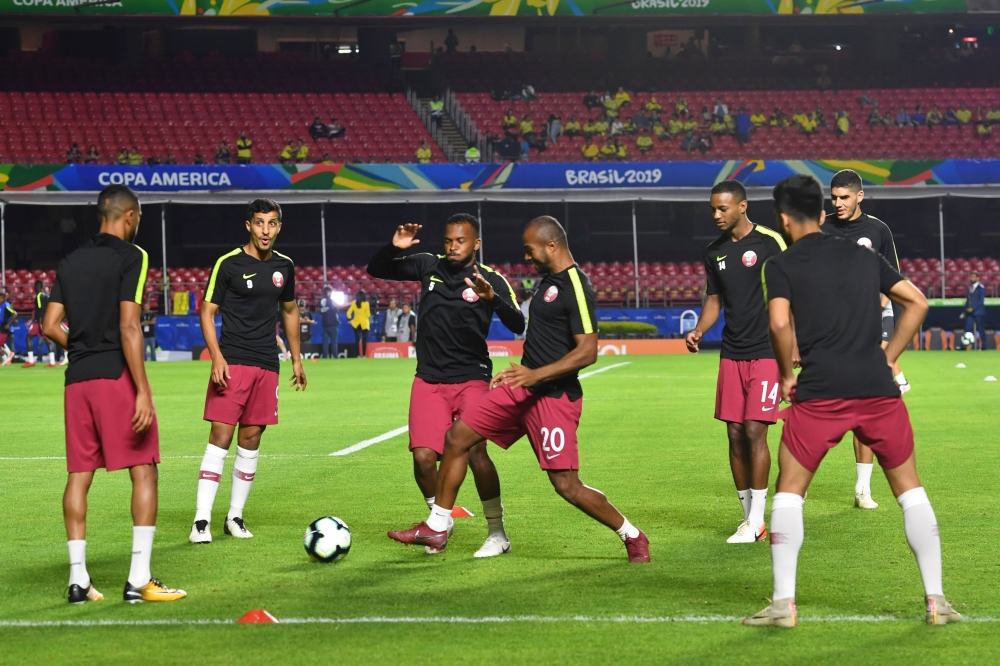 Players of Qatar warm up before their Copa America football tournament group match against Colombia at the Cicero Pompeu de Toledo Stadium, also known as Morumbi, in Sao Paulo, Brazil, on June 19, 2019.  AFP / Nelson Almeida 