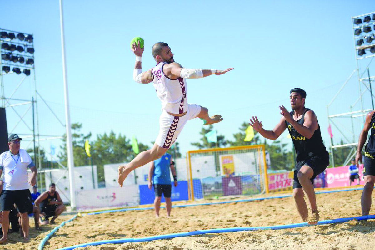 A Qatari player prepares to score against Iran during the semi-final of the AHF Asian Beach Handball Championships in Weihai, China, yesterday. 