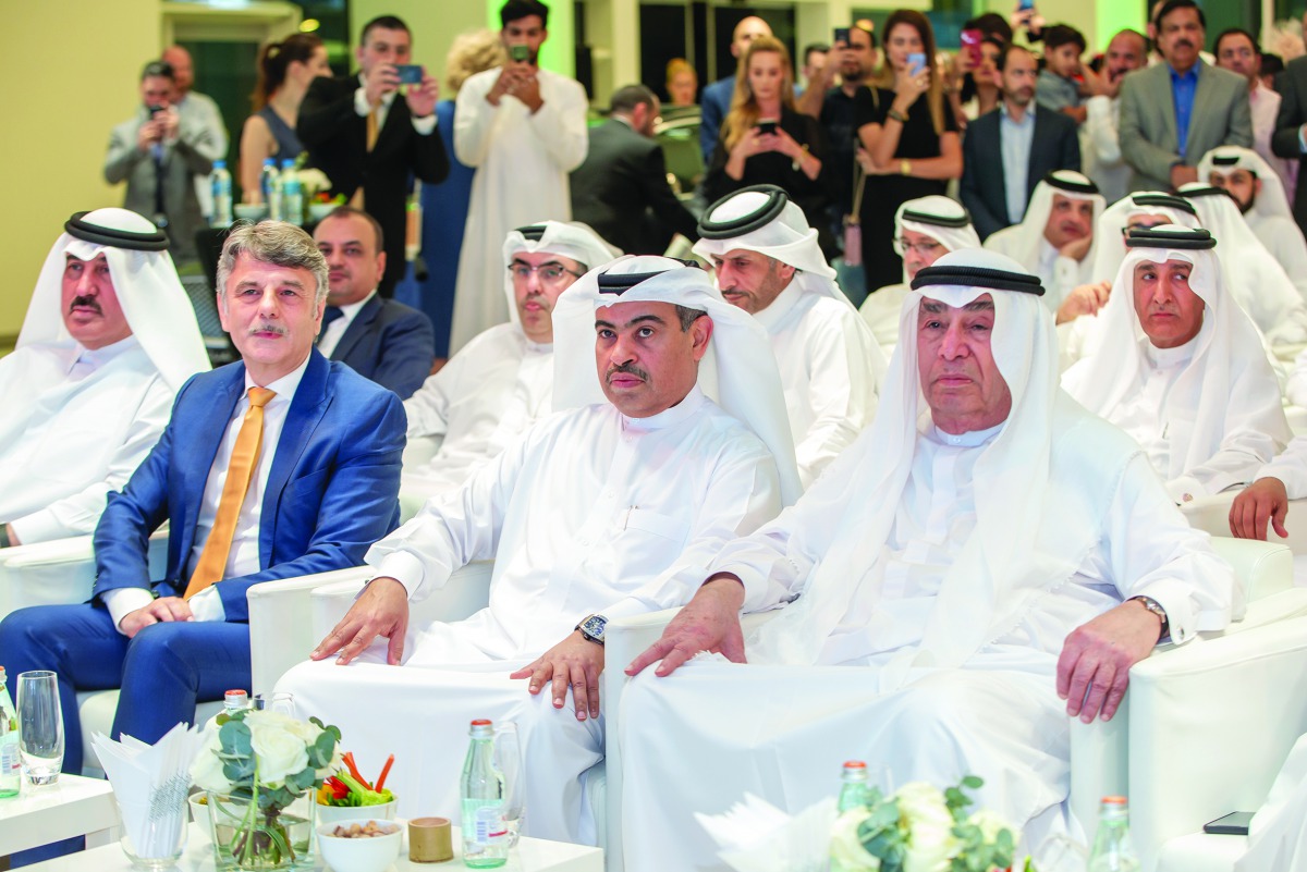 H E Ali bin Ahmed Al Kuwari (second right), Minister of Commerce and Industry; and Hussain Ibrahim Al Fardan (right), and other dignitaries during the opening of Jaguar Land Rover sales showroom in Lusail City on Monday. 