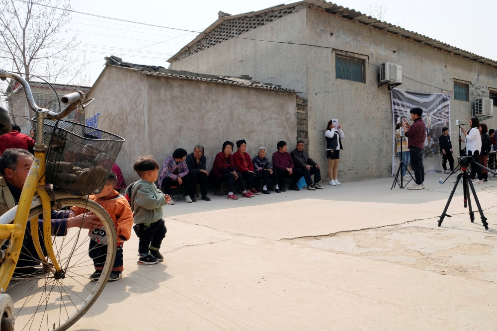 Staff members from Qian Ji Data Co take photos of the villagers for a facial data collection project, which would serve for developing artificial intelligence (AI) and machine learning technology, in Jia county, Henan province, China March 20, 2019. Pictu