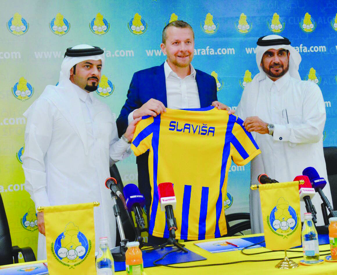 Al Gharafa SC’s new Serbian coach Slavisa Jokanovic holding a team jersey with club officials during a press conference held in Doha, yesterday.