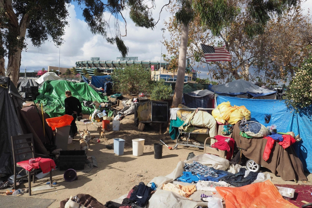 A homeless encampment made of tents and tarps lines the Santa Ana riverbed near Angel Stadium in Anaheim, California, January 25, 2018. AFP/Robyn Beck