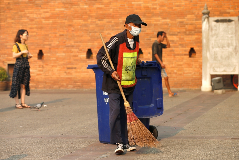 A man sweeps the ground near a palace in Chiang Mai, Thailand, April 3, 2019. Reuters / Soe Zeya Tun
