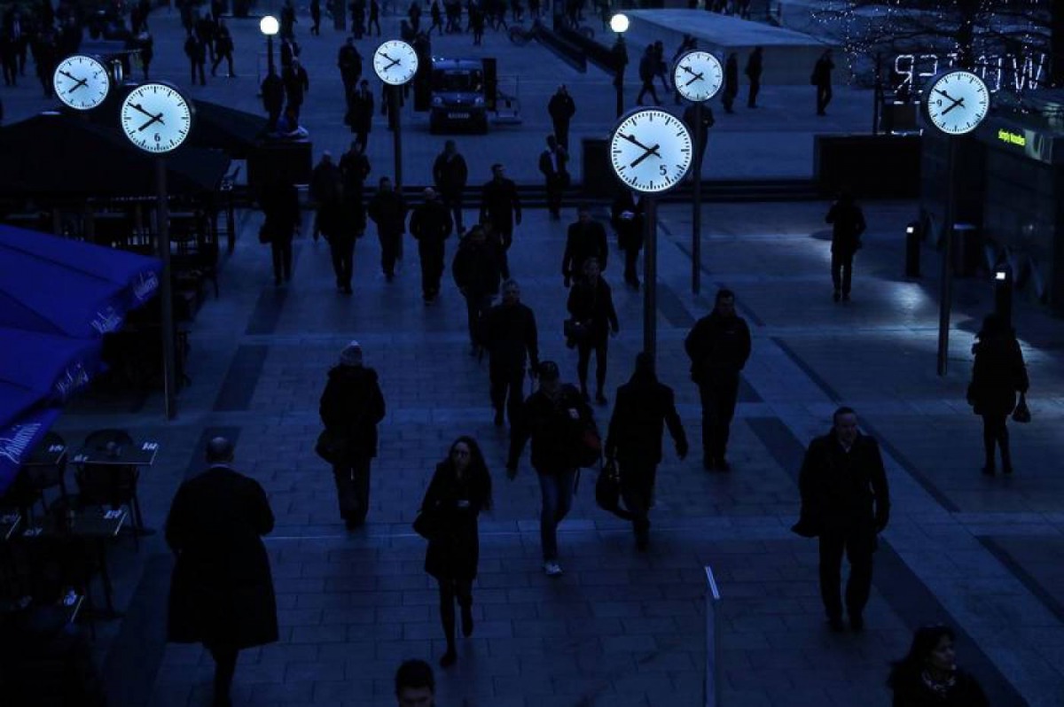 Workers walk to work during the morning rush hour in the financial district of Canary Wharf in London, January 26, 2017. Reuters/Eddie Keogh