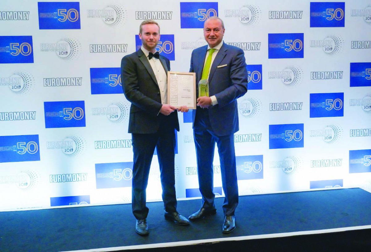 Bassel Gamal, Group CEO of QIB (right), receiving the award.