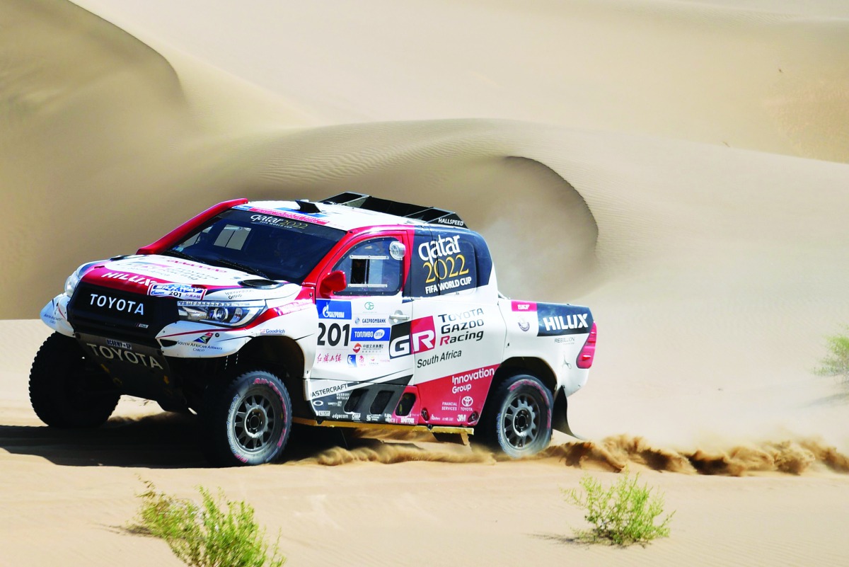 Qatar’ Nasser Al Attiyah and France’s Mathieu Baumel compete with their Toyota Hilux during the 9th stage of the Silk Way Rally 2019 from Alashan to Jiayuguan, yesterday. 
