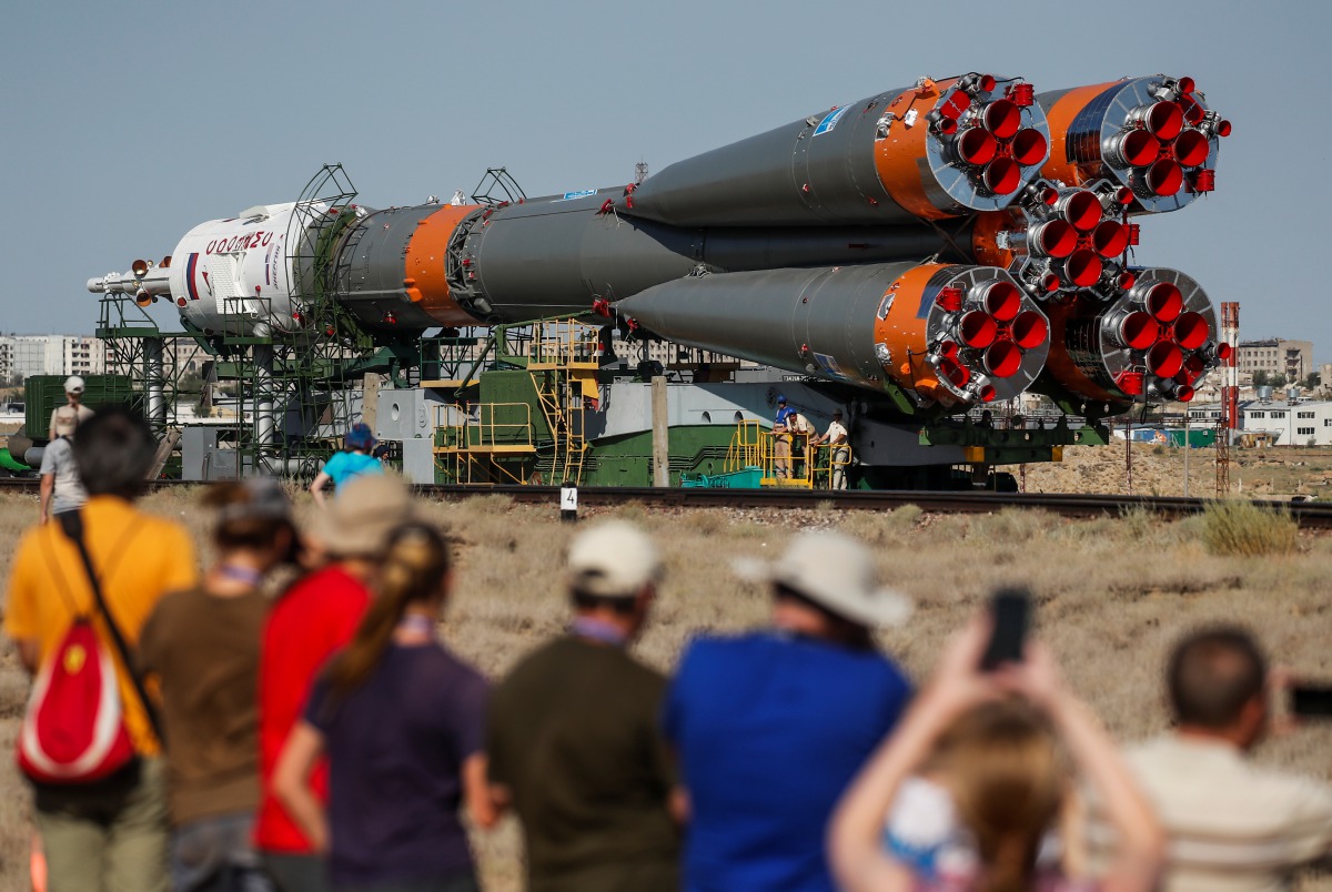 People watch as Soyuz MS-13 spacecraft for the new International Space Station (ISS) crew, comprising NASA astronaut Andrew Morgan, Luca Parmitano of ESA (European Space Agency) and Alexander Skvortsov of the Russian space agency Roscosmos, is transported