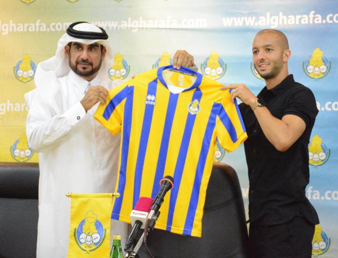 Al Gharafa’s new signing, Algerian international Sofiane Hanni holding a team jersey with an official during the official unveiling of the former Spartak Moscow player  in Doha, yesterday.