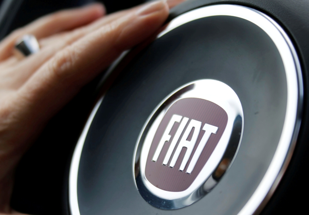 FILE PHOTO: The logo of Italian carmaker Fiat is seen on a steering wheel as a woman drives her car in Bordeaux, France, January 1, 2017. REUTERS/Regis Duvignau