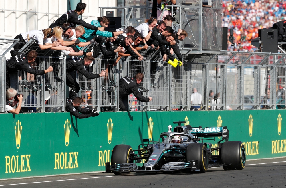 Mercedes' Lewis Hamilton and team celebrate winning the Hungarian Grand Prix REUTERS/Bernadett Szabo