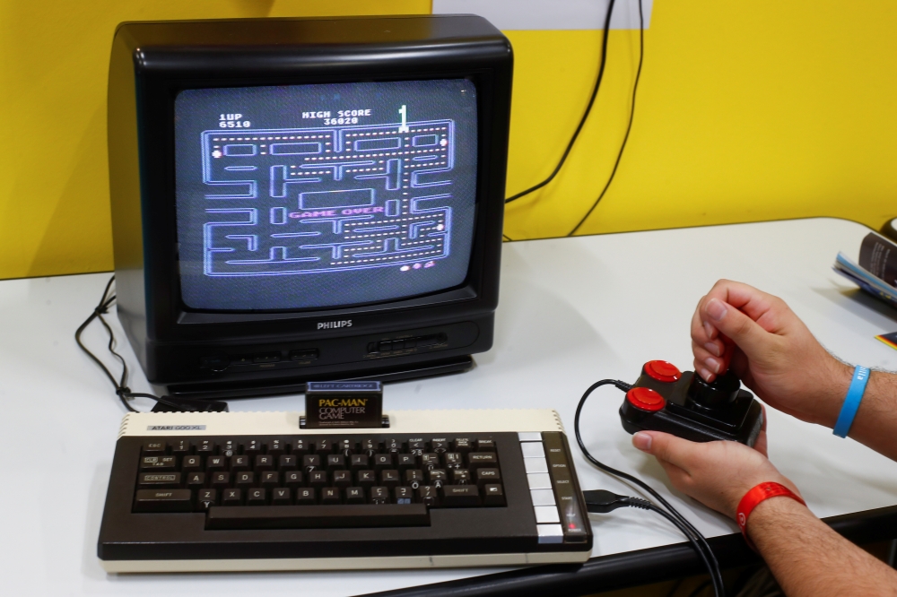 A gamer plays Pac-Man, first released in 1980 on a historic Commodore 64 computer in the hall for retro games of Europe's leading digital games fair Gamescom, which showcases the latest trends of the computer gaming scene in Cologne, Germany, August 21, 2