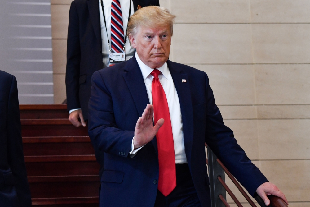 US President Donald Trump arrives to attend a lunch on 