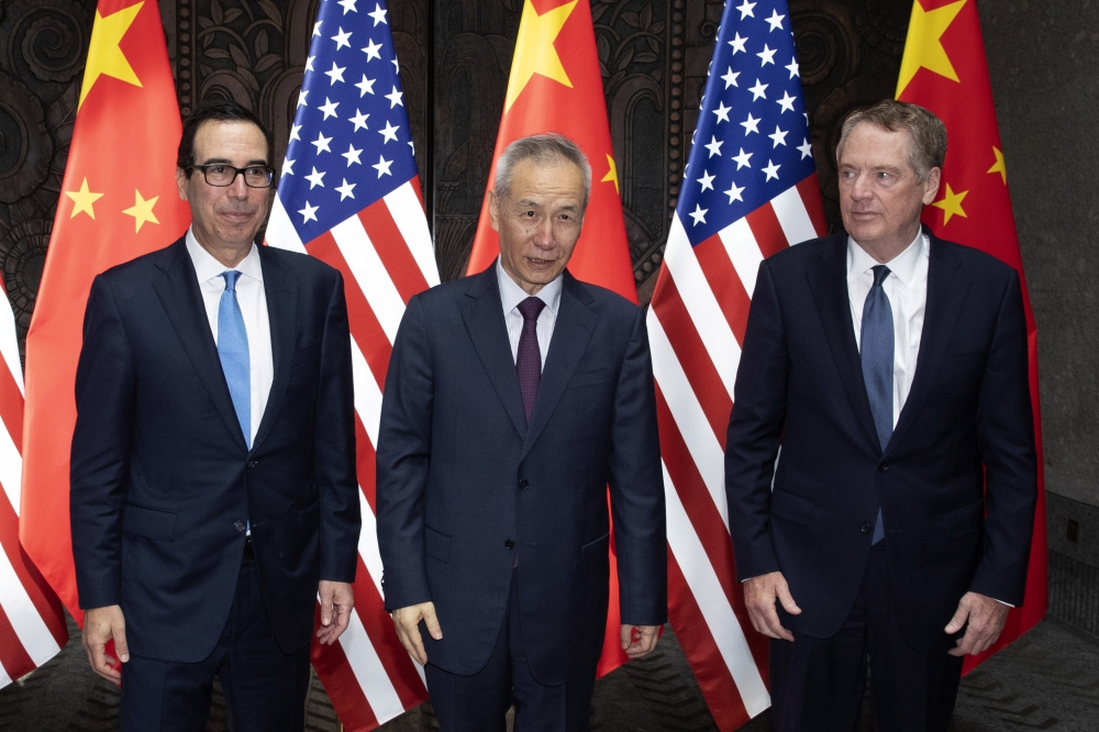 In this file photo taken on July 30, 2019, Chinese Vice Premier Liu He (C), US Trade Representative Robert Lighthizer (R) and Treasury Secretary Steve Mnuchin pose for photos before holding talks at the Xijiao Conference Center in Shanghai AFP / Pool / Ng
