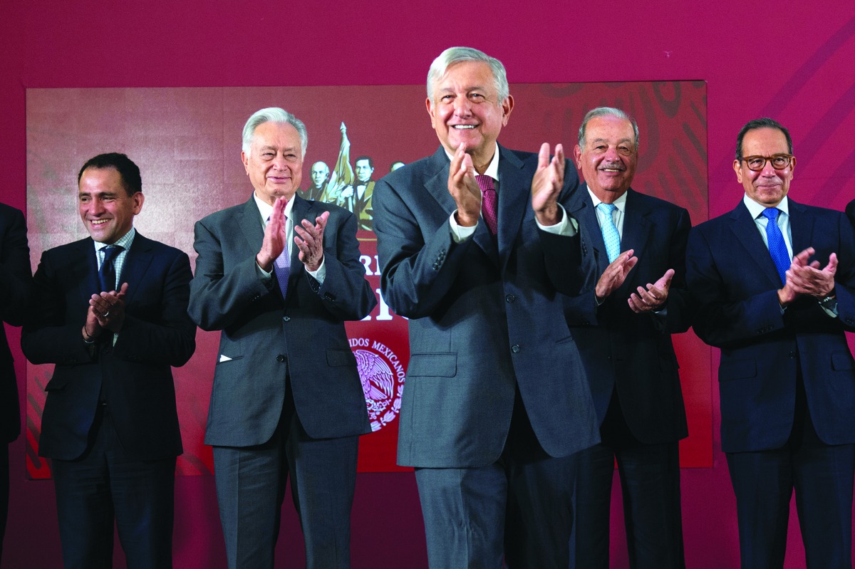 Mexico's President Andres Manuel Lopez Obrador (C), Mexico's Finance Minister Arturo Herrera (L), Federal Electricity Commission (CFE) Manuel Bartlett, Mexican tycoon Carlos Slim (2nd R) and Business Coordinating Council (CCE) Carlos Salazar applaud after