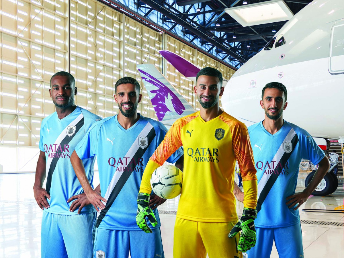 Al Sadd players sporting new team jerseys, featuring Qatar Airways logo.