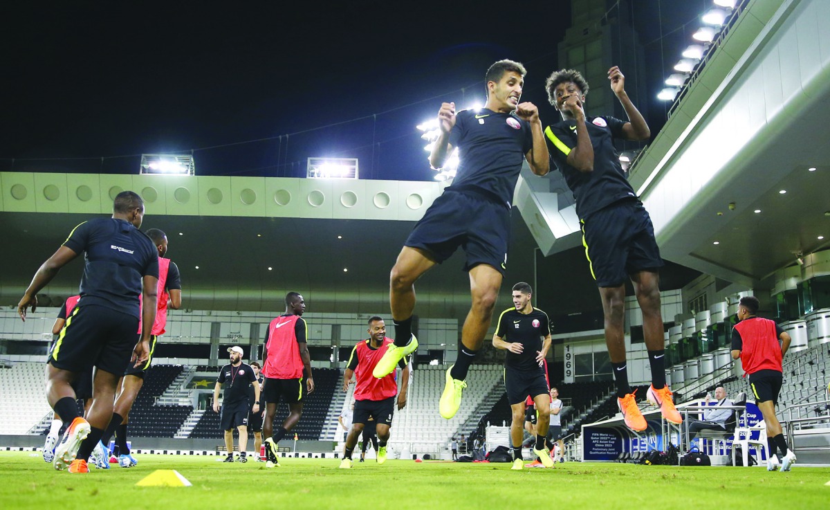 Qatari players take part in a practice session at the Al Sadd Stadium, yesterday, on the eve of their match against Afghanistan.