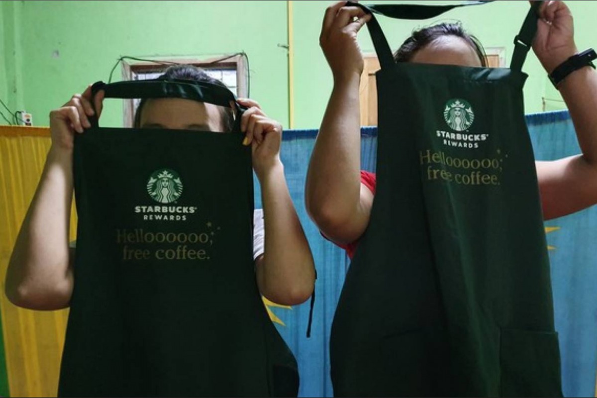 Workers show Starbucks aprons at a dormitory near a factory in Thailand's Mae Sot district in August 2019. Thomson Reuters Foundation/Nanchanok Wongsamuth