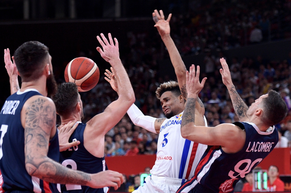Dominican Republic's Victor Liz (C) fights for the ball with France's Paul Lacombe (R) and France's Vincent Poirier (L) during the Basketball World Cup Group G game between Dominican Republic and France in Shenzhen on September 5, 2019. AFP / Nicolas Asfo