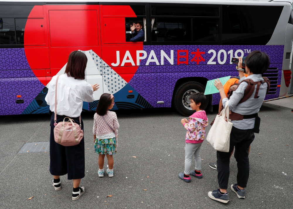 Ireland's rugby players wave from their bus after the Team Welcome Ceremony for Ireland team ahead of the start of the Rugby World Cup in Chiba, east of Tokyo, Japan September 13, 2019. REUTERS/Issei Kato