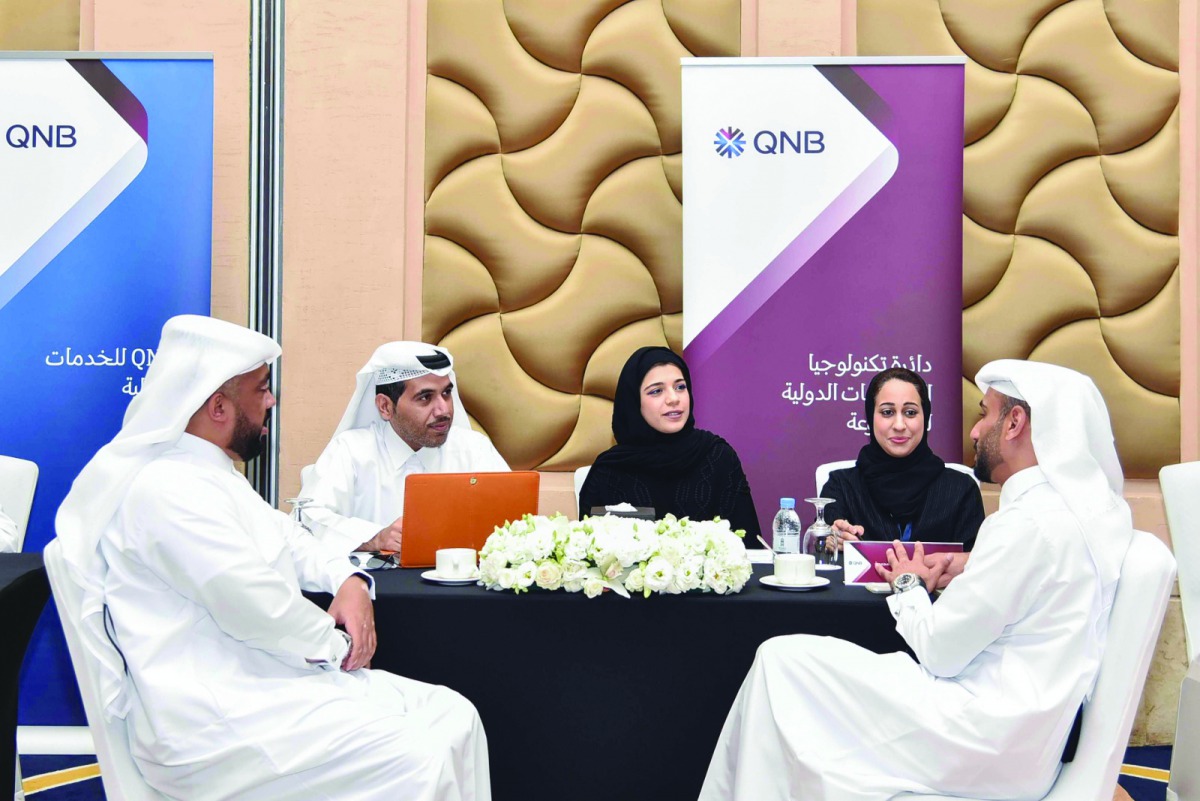 QNB officials and Open Career Day visitors at one of the help desks.