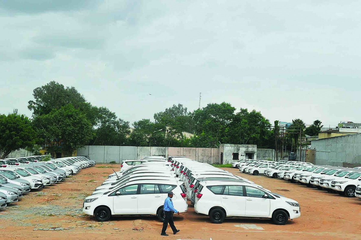 In this photograph taken on September 11, 2019, a security guard patrols a holding area for new vehicles near a godown on the outskirts of Hyderabad. AFP / Noah Seelam