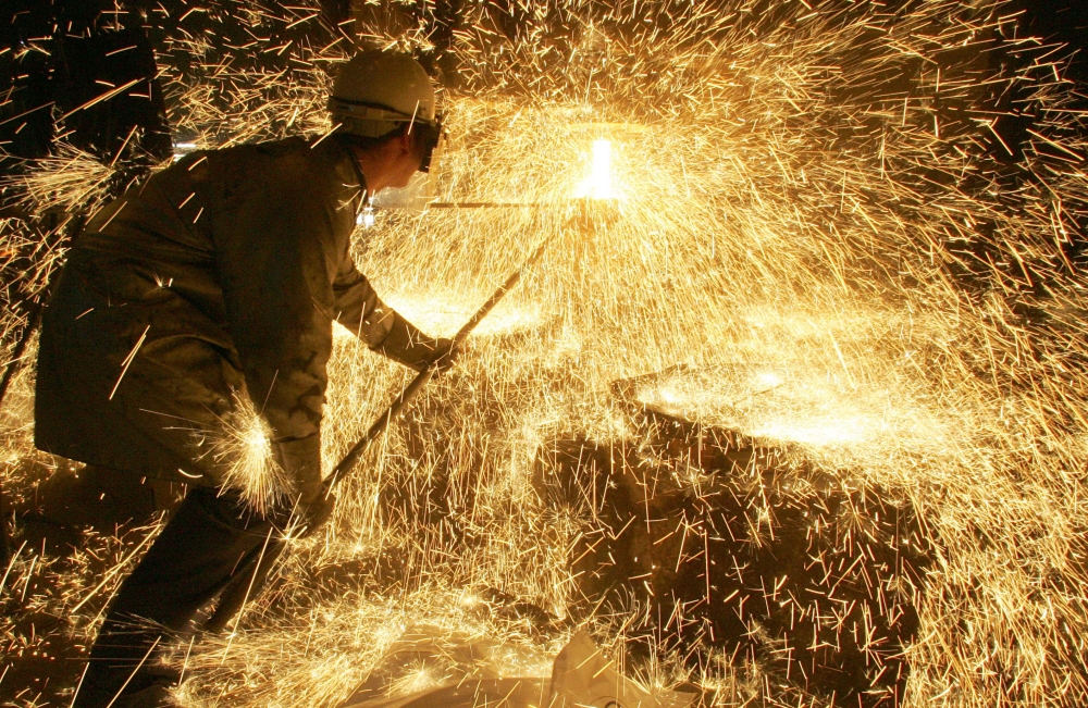 In this file photo taken on April 12, 2006 an iron and steel worker makes a test on a casting at Ascometal factory in Fos-sur-Mer. AFP/Boris Horvat