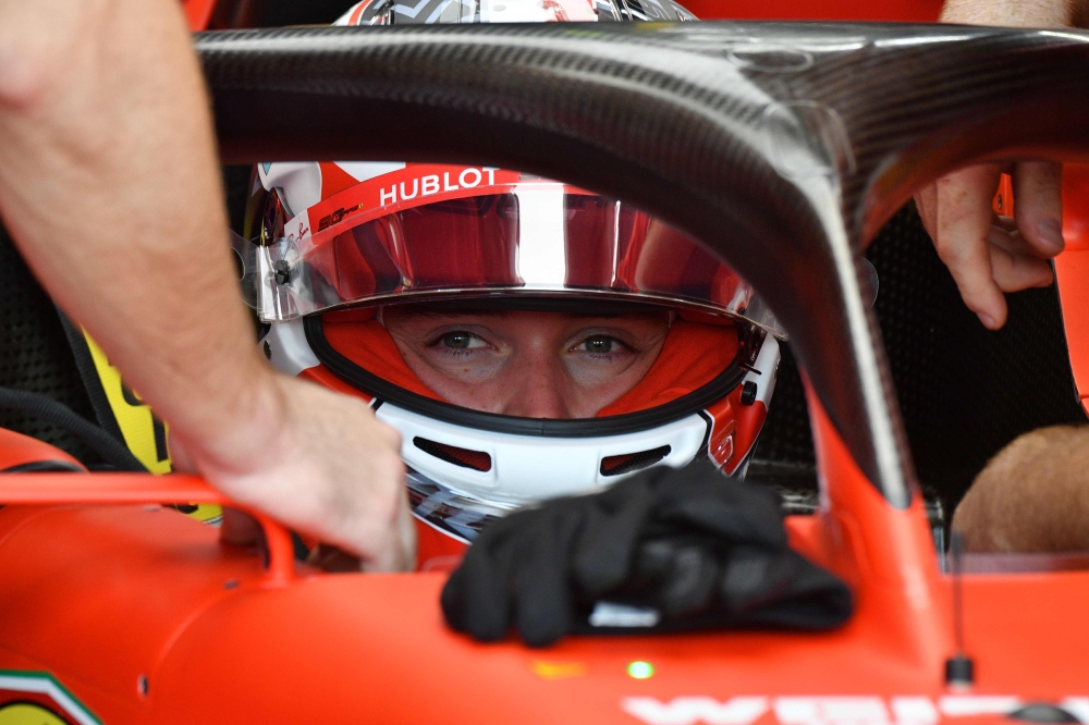 Ferrari's Monegasque driver Charles Leclerc is pictured in the pits as he takes part in the first practice session for the Formula One Singapore Grand Prix at the Marina Bay Street Circuit in Singapore on September 20, 2019. / AFP / Mladen ANTONOV