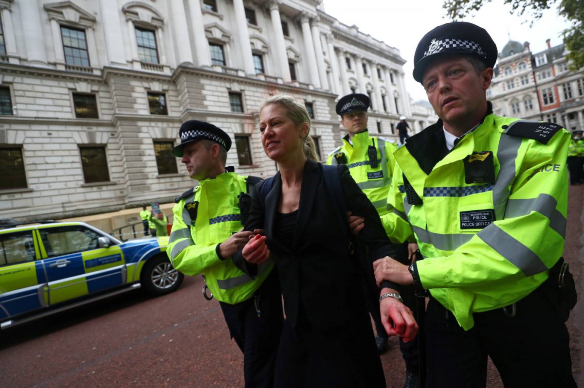 Police take away a protestor during an Extinction Rebellion demonstration outside the Treasury building in London, Britain October 3, 2019. Reuters/Simon Dawson
 