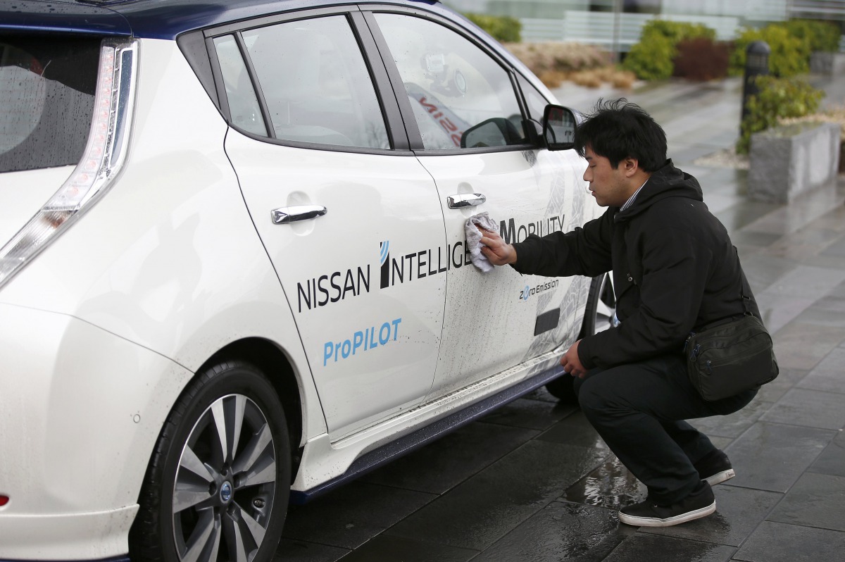 A technician cleans a modified Nissan Leaf driverless car in London, February 27, 2017. Reuters  / Peter Nicholls