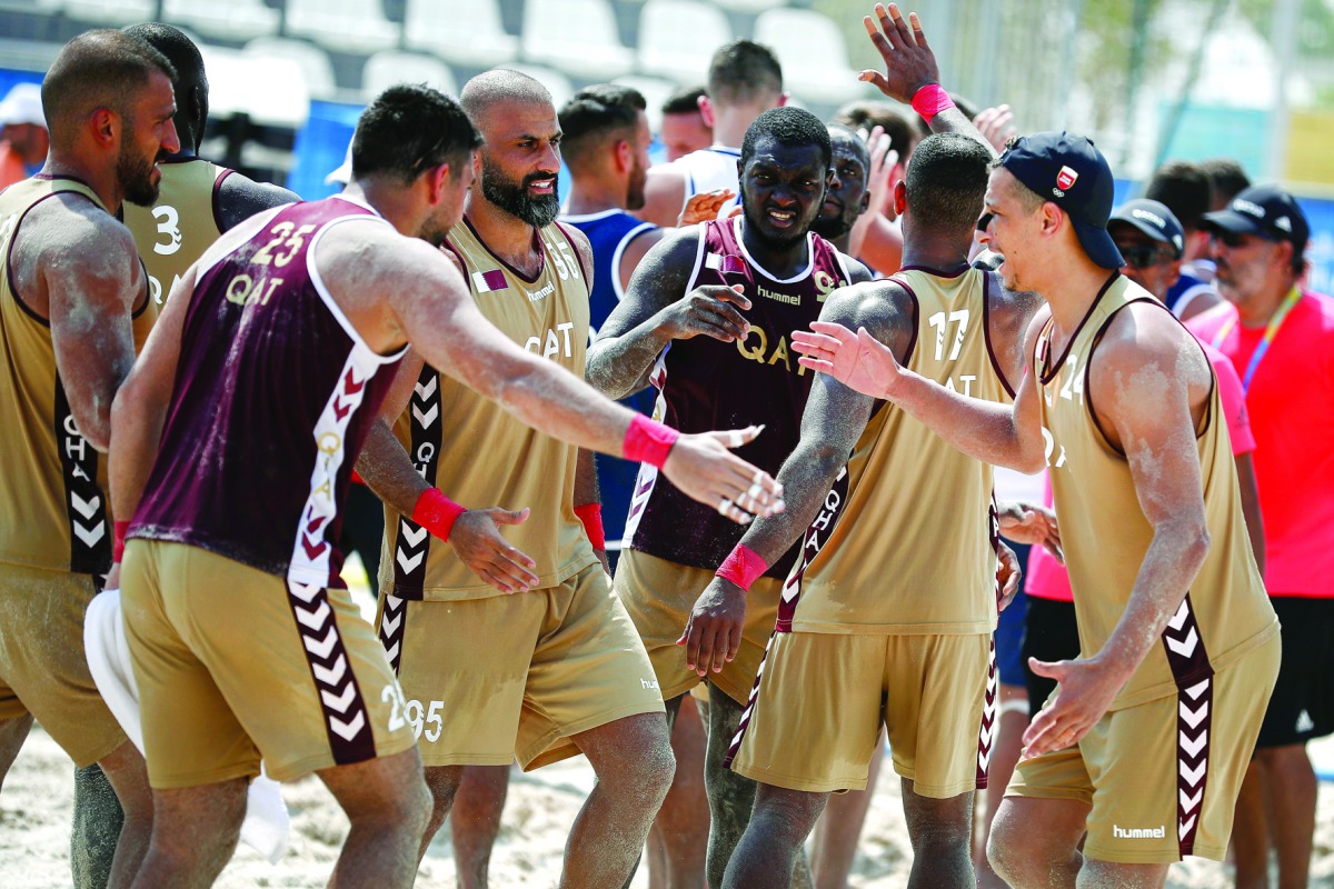 Qatari beach handball players celebrate after winning their opening match against Croatia during the ANOC World Beach Games at Al Gharafa, yesterday.