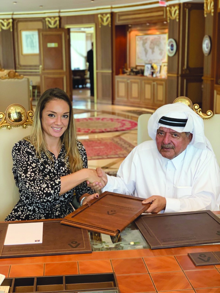 Sheikh Faisal bin Qassim bin Faisal Al Thani (right), Chairman of QBA, and Ceca Tosic, TBY Country Director for Qatar, during the signing ceremony.