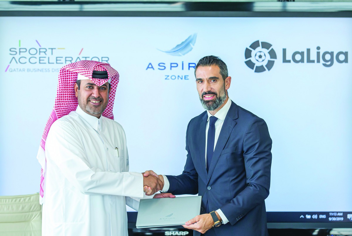 Abdulla Nasser Al Naimi (left), Director General of Aspire Logistics and Fernando Sanz, Director of International Institutional Relations and Director of the LaLiga Ambassadors and Legends Project exchanging documents during the MoU signing ceremony. 