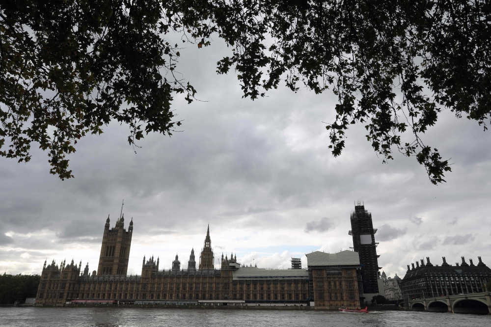 Britain's House of Parliament are pictured across the River Thames in London, on October 15, 2019. AFP / ISABEL INFANTES
