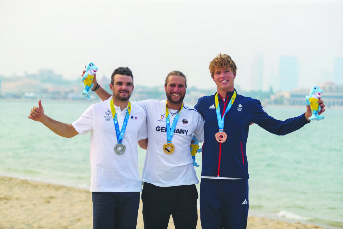 The podium winners of the men’s kitefoil racing event, Florian Gruber  (Germany, gold), Nicolas Parlier (France, silver) and Guy Bridge (Great Britain, bronze) pose for a photograph. Picture:  Laurel Photo Services