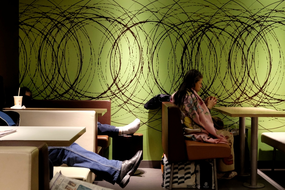 People sleep inside a McDonalds restaurant at midnight hours at Tsim Sha Tsui district in Hong Kong, January 23, 2018. Reuters / Bobby Yip