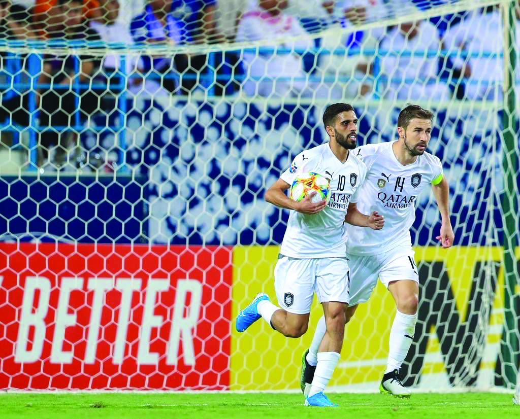 Al Sadd’s Hassan Al Haydos (left) celebrates with captain Gabi Fernández after scoring their third goal against Al Hilal, yesterday. 