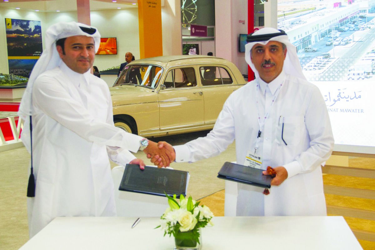 The officials shaking hands after the signing ceremony.