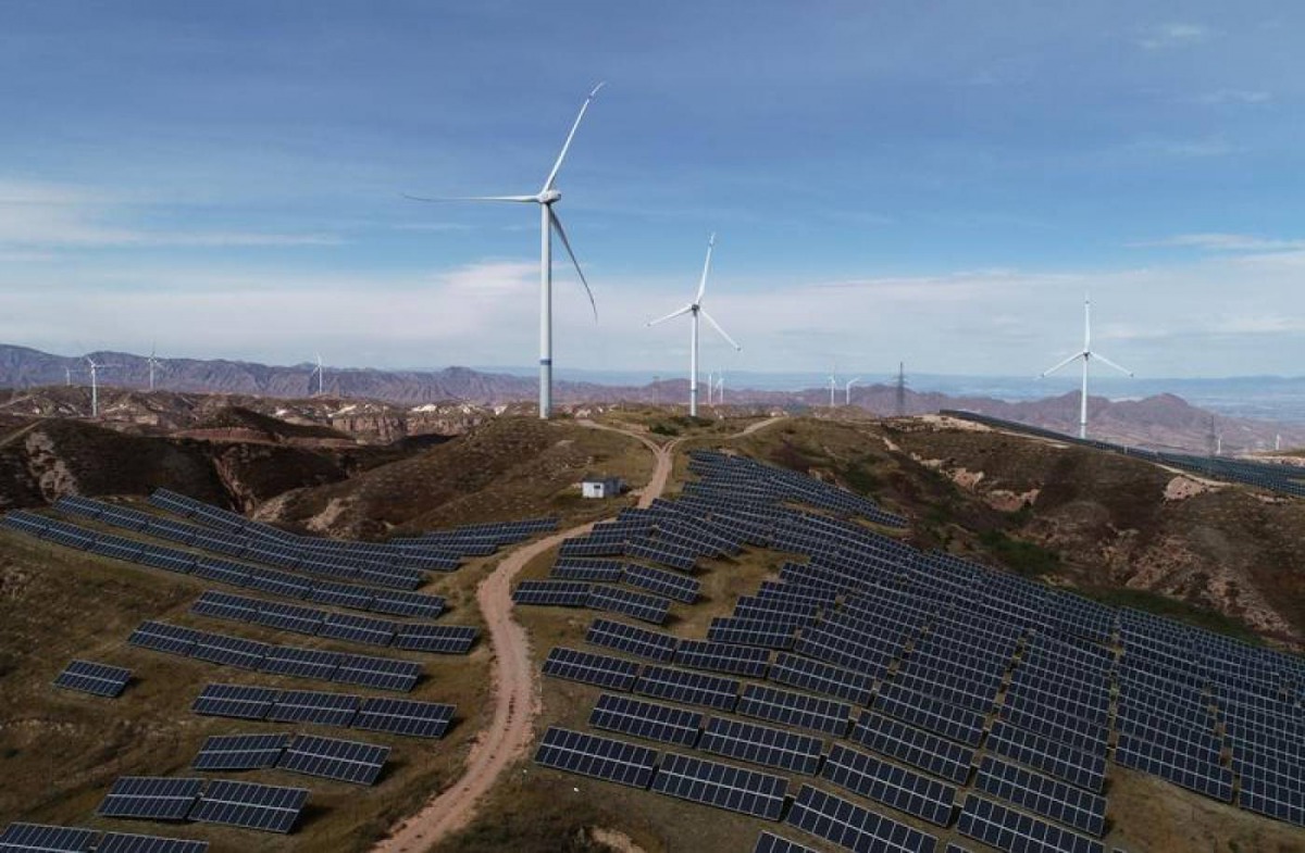 Wind turbines and solar panels are seen at a wind and solar power plant in China, October 29, 2018. Reuters