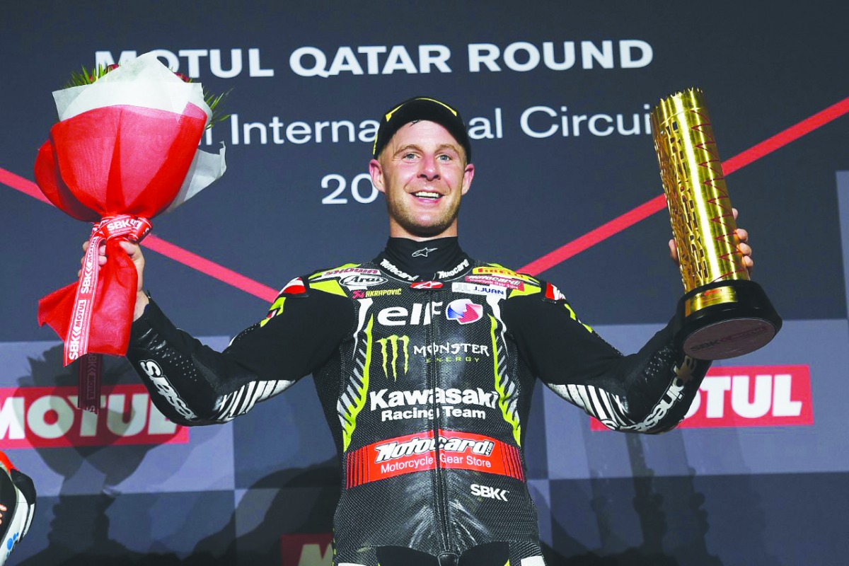 British racing star Jonathan Rea celebrates on the podium after winning the last race of the 2019 WorldSBK Championship at the Losail International Circuit yesterday.