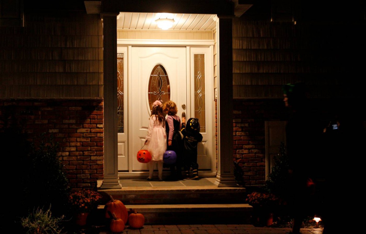  Children wait at a doorway as they go 