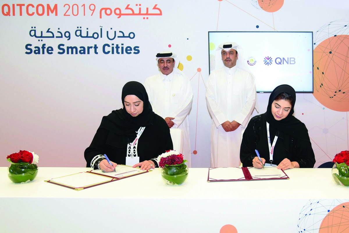 Minister of Transport and Communications, H E Jassim bin Saif Al Sulaiti, (standing left), and Acting Chief Executive Officer of QNB Group, Abdullah Mubarak Al Khalifa (standing right), witnessing  the MoU signing held on the sidelines of QITCOM 2019 yest